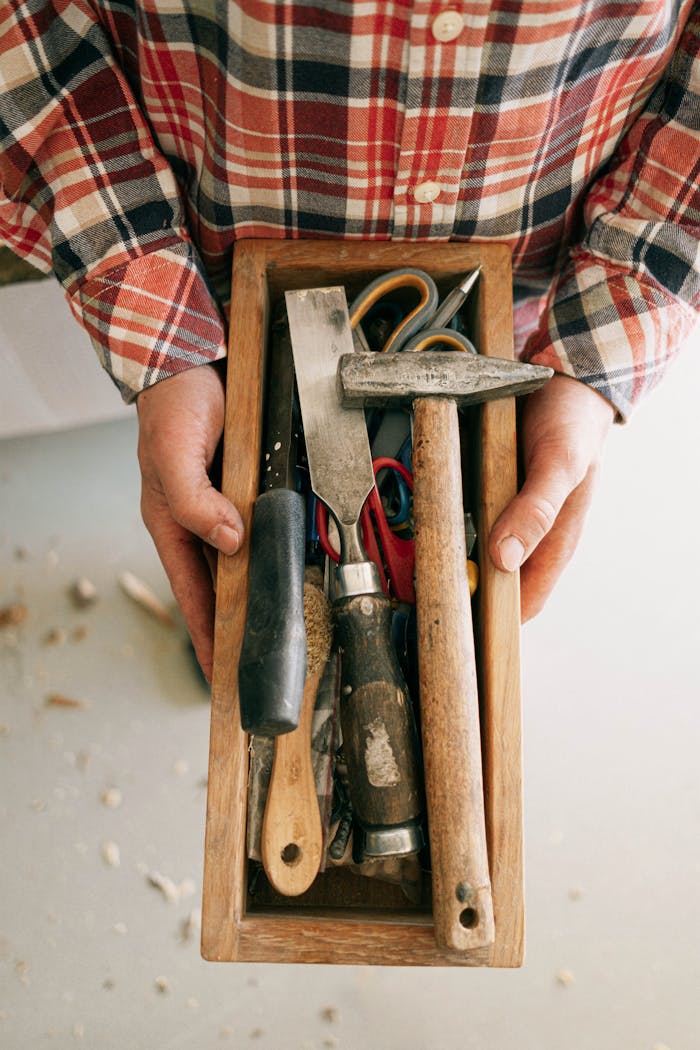 Person Holding Brown Wooden Handle